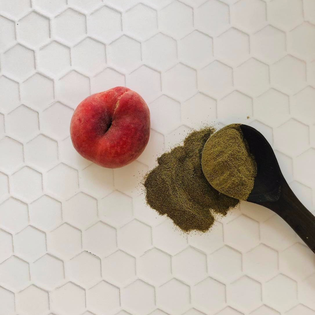 peach next to seaweed powder for face mask