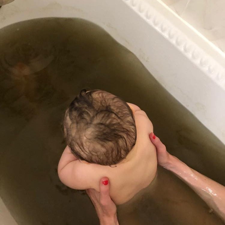 
                  
                    Baby soaking in bath with Aalgo sea weed powder
                  
                